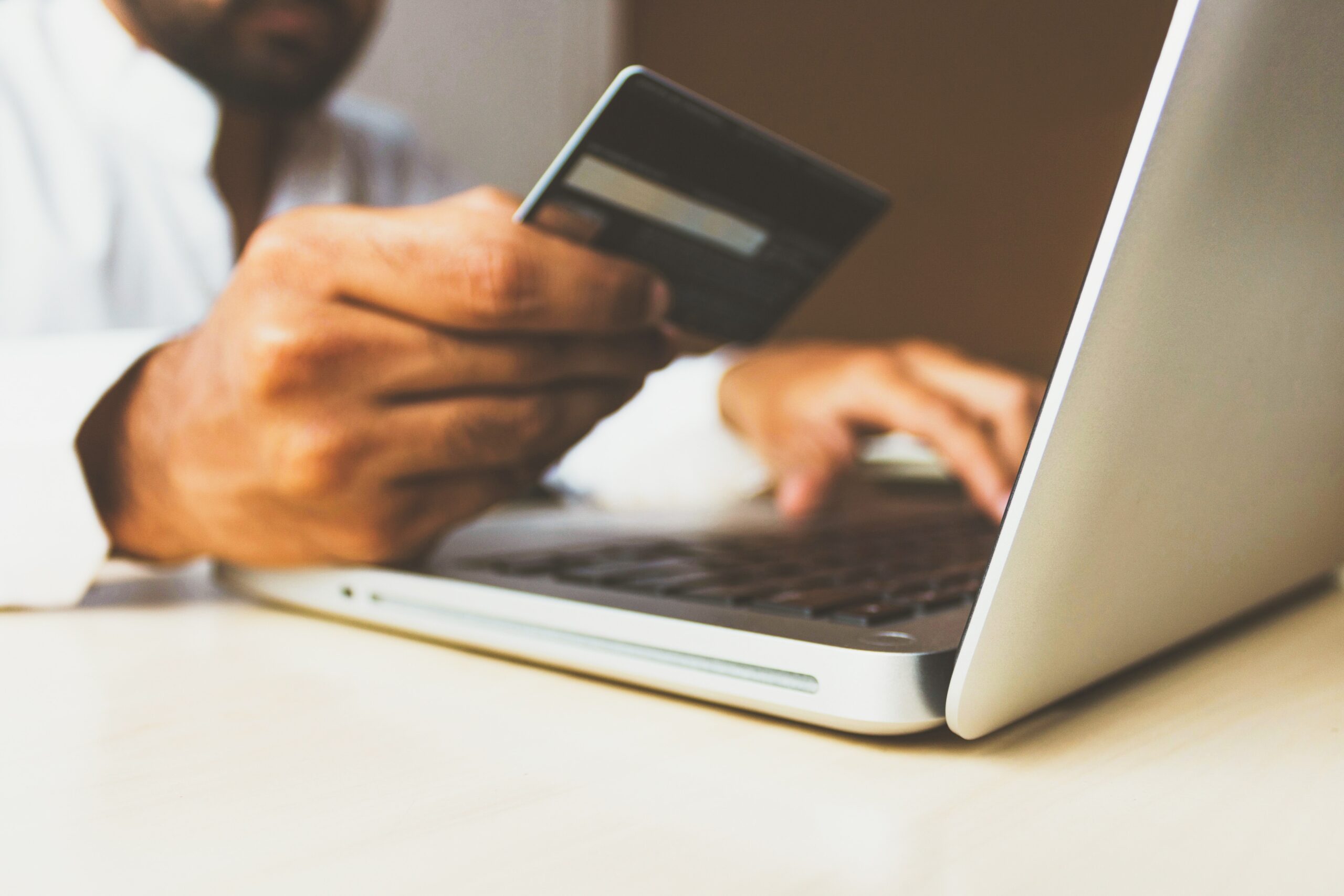 A Man Using a Credit Card from Unsplash